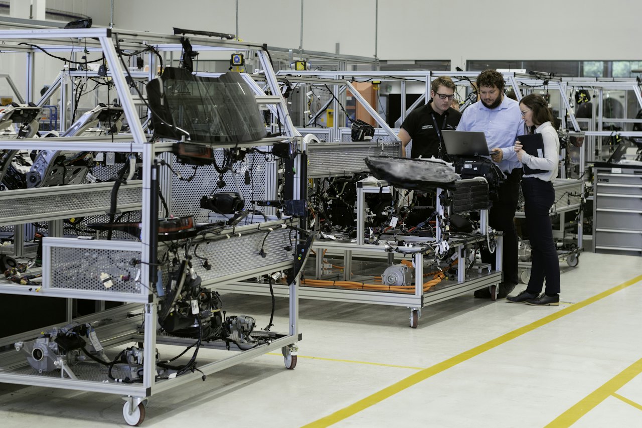 Engineers reviewing work on a manufacturing line