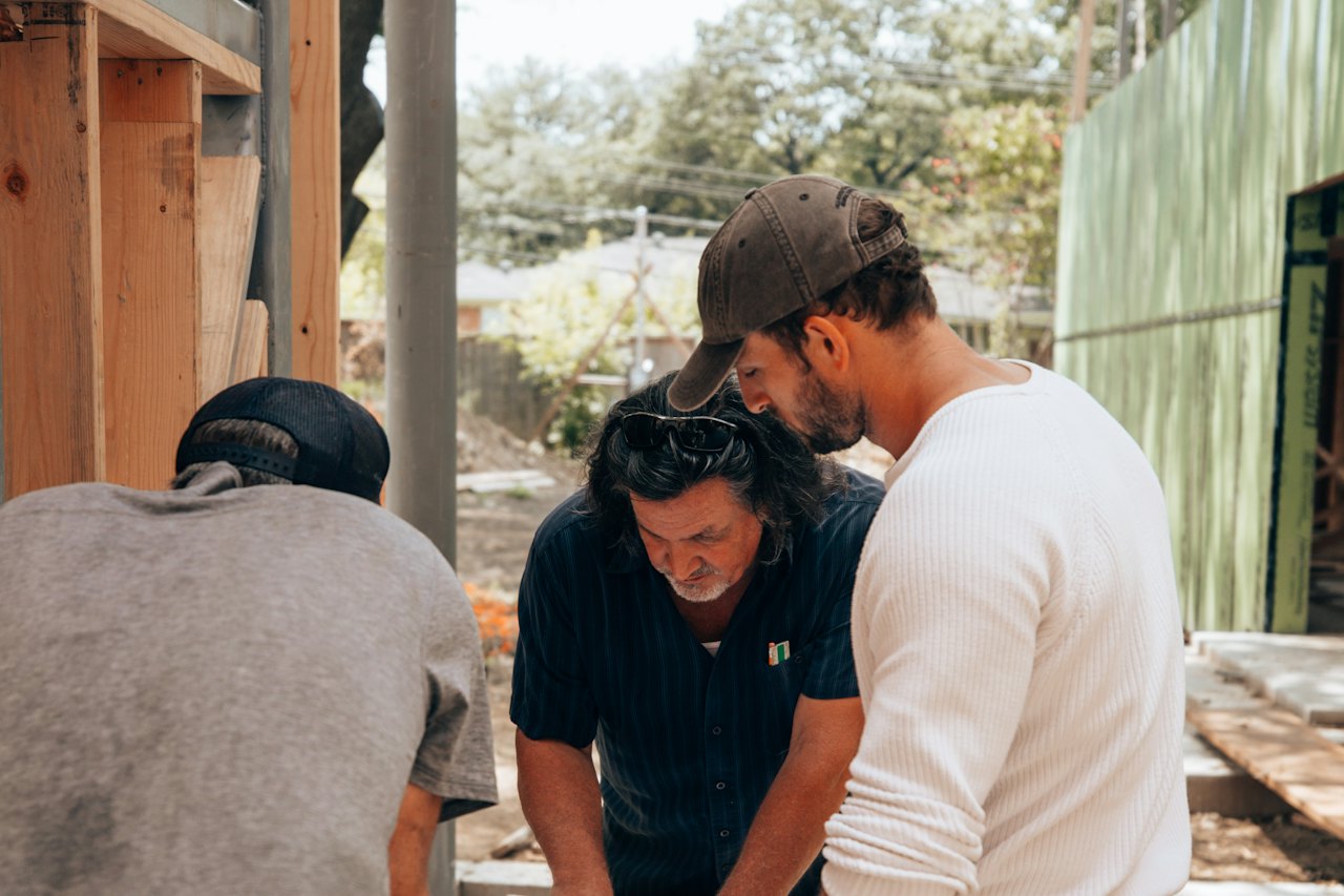 Project team reviewing plans on site